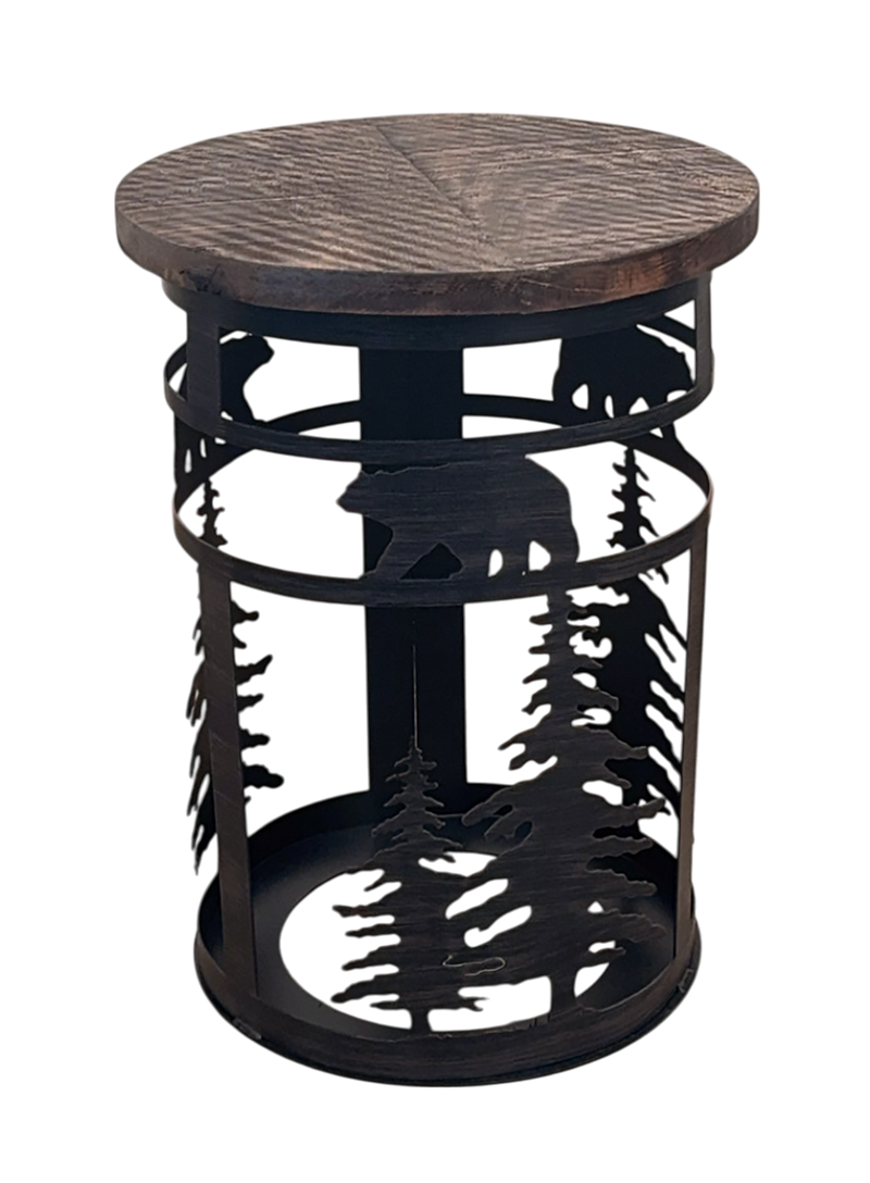 Iron cylinder metal end table with pine tree and bear accent with a rough wood sawn top on a white background.