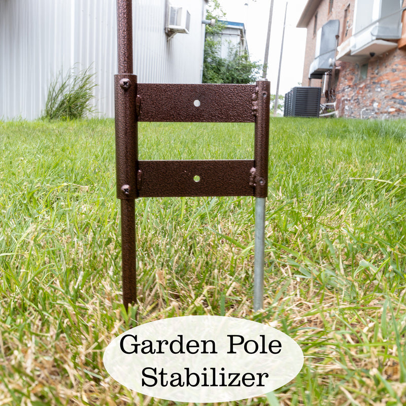 Garden pole stabilizer in grass with a house in the background