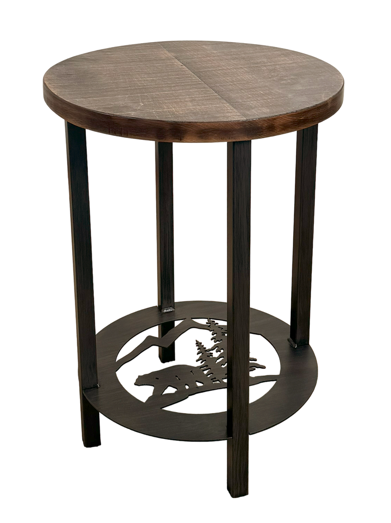 Round metal bear with pine tree design end table with a rough sawn wood top.