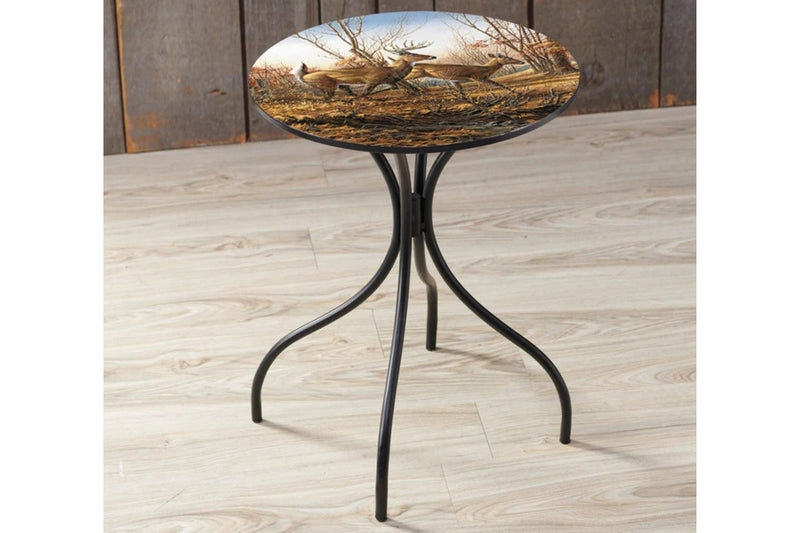 Round metal table with deer design on a wooden floor