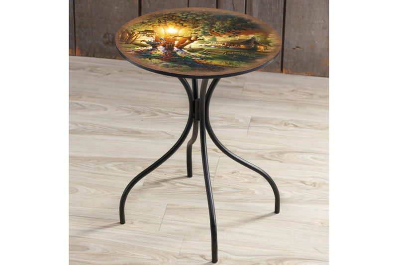 Decorative metal side table with artwork by Terry Redlin titled "Colors of Spring". The table is on a wooden floor.