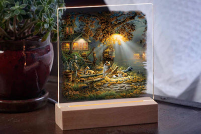 Acrylic table top night light featuring the artwork of dogs and cats resting under an evening light in front of a farmhouse with a wooden base.