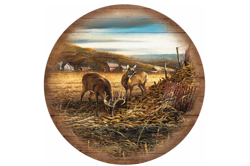 Artwork of two deer in a field eating corn by Terry Redlin.