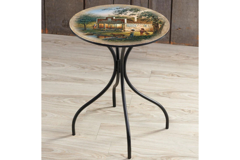 Small round metal side table featuring artwork by Terry Redlin titled "Summertime". The table is sitting on a wooden floor.