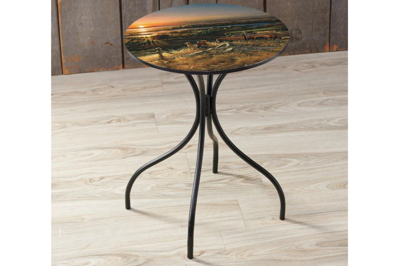 Small round table with a scenic design on a wooden floor