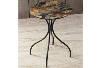 Round metal side table featuring wood duck artwork by Rosemary Millette. The table is sitting on a wood floor.